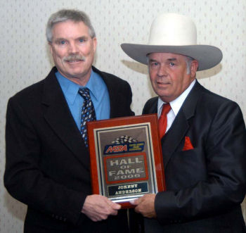 Johnny Anderson holds award